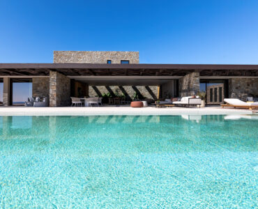 Private pool in front of the villa's stone façade at Aether Private Retreat - Grand Villa, Aleomandra, Mykonos