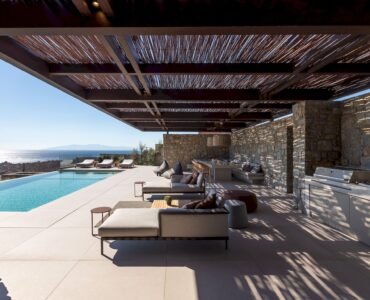 Infinity pool next to the covered stone terrace at Aether Private Retreat - Grand Villa, Aleomandra, Mykonos