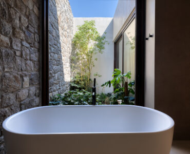 Freestanding bathtub with a view of the planted courtyard at Aether Private Retreat - Grand Villa, Aleomandra, Mykonos