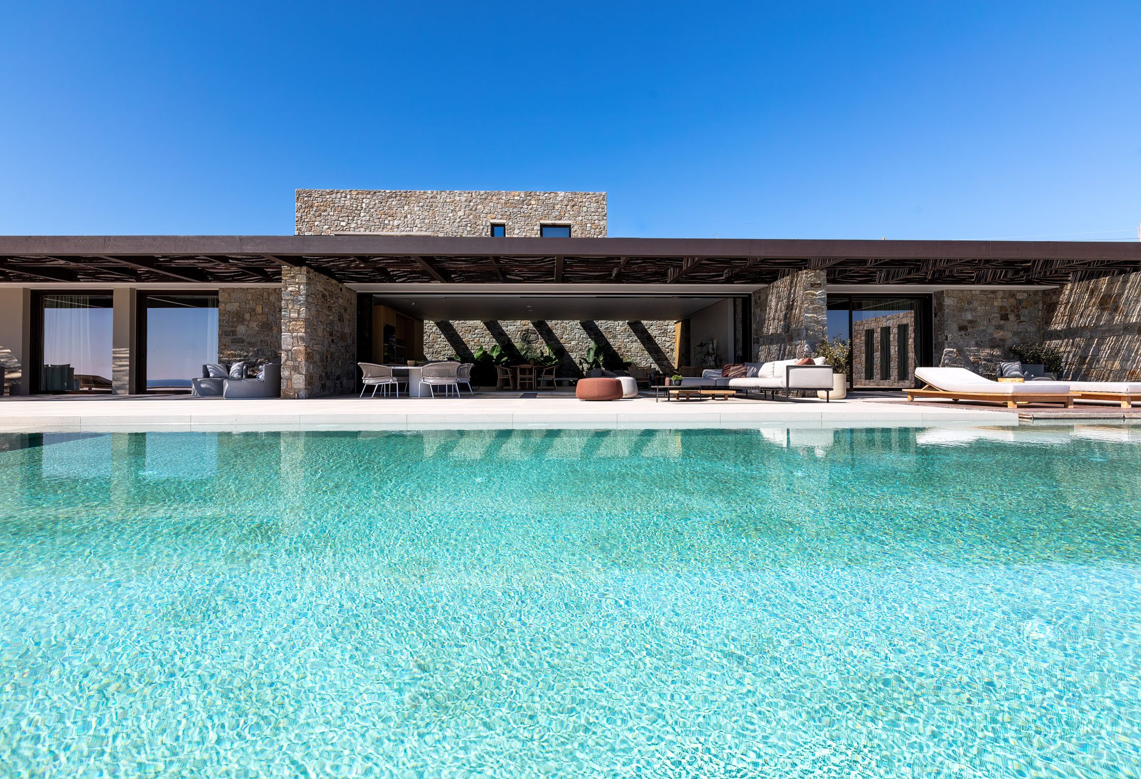 Private pool in front of the villa's stone façade at Aether Private Retreat - Ground Floor, Aleomandra, Mykonos