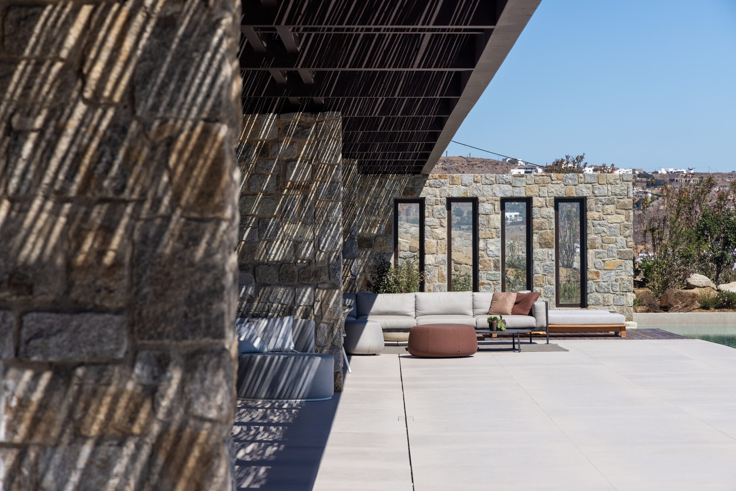 Stone terrace with timber pergola and sea views at Aether Private Retreat - Ground Floor, Aleomandra, Mykonos