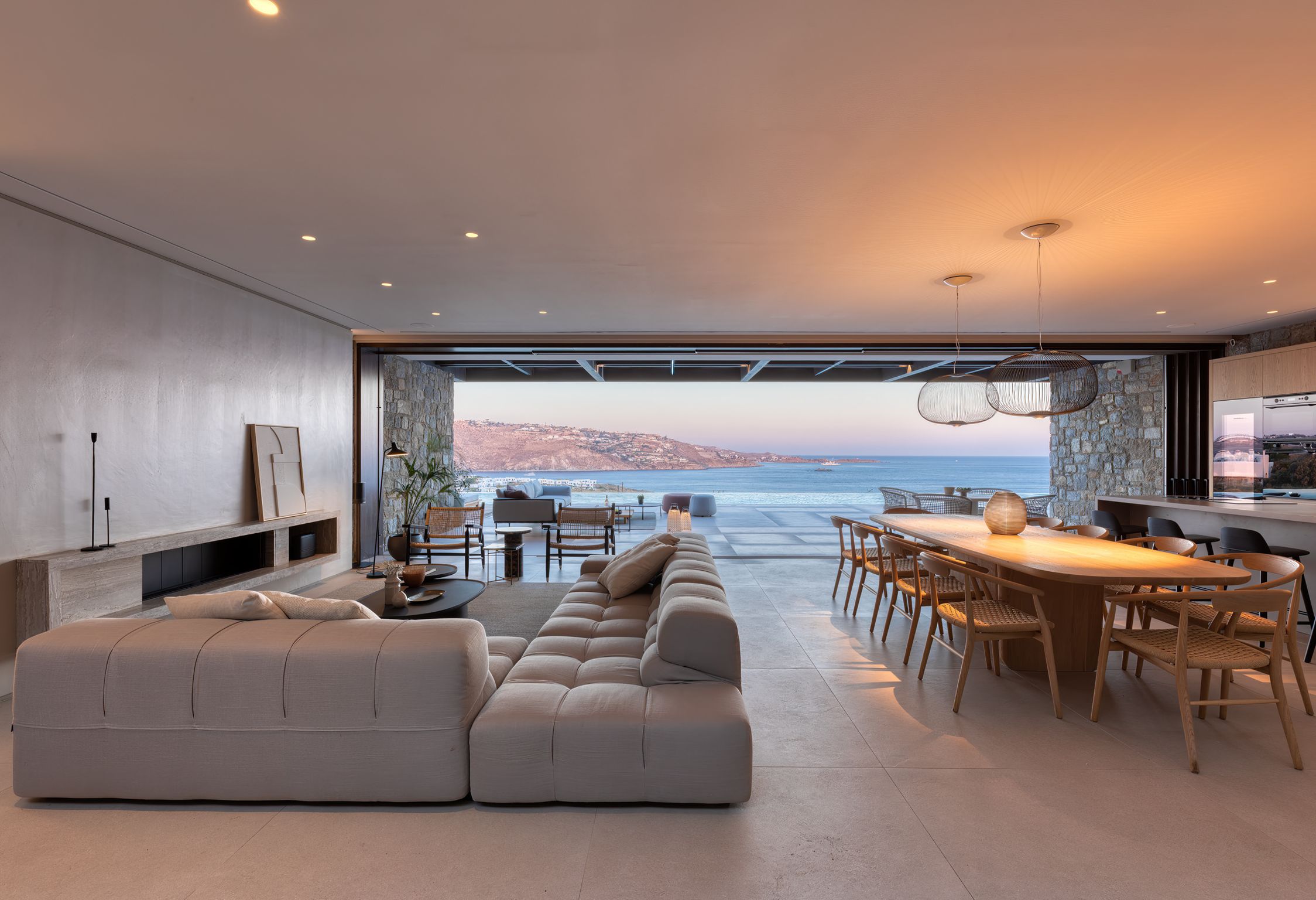 Living and dining area at sunset with views of the sea at Aether Private Retreat - Ground Floor, Aleomandra, Mykonos