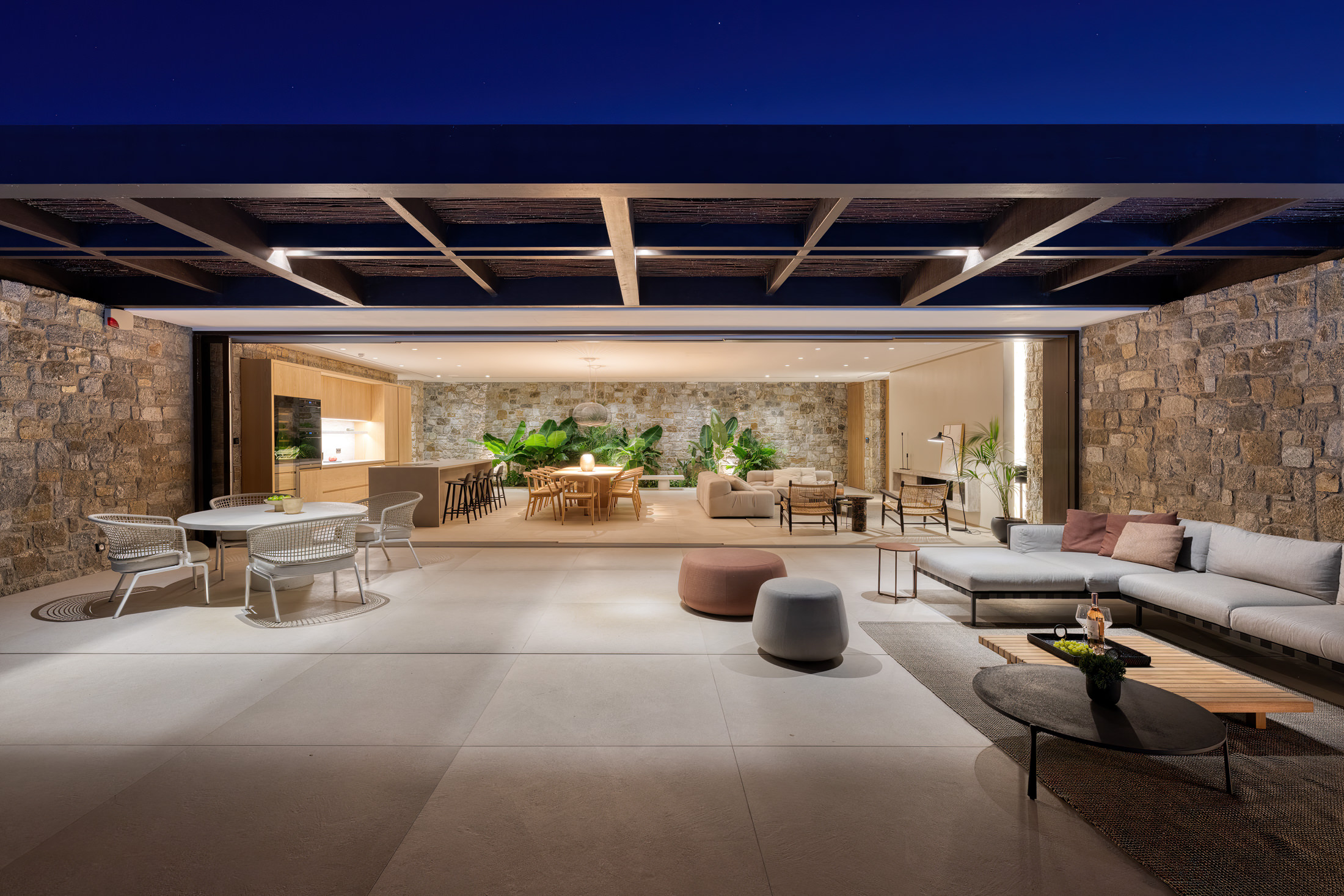 Covered outdoor lounge lit at night at Aether Private Retreat - Ground Floor, Aleomandra, Mykonos