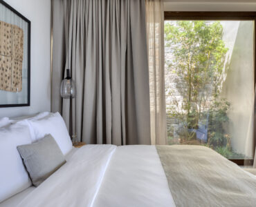 Bedroom with picture window onto the planted garden at Aether Private Retreat - Ground Floor, Aleomandra, Mykonos