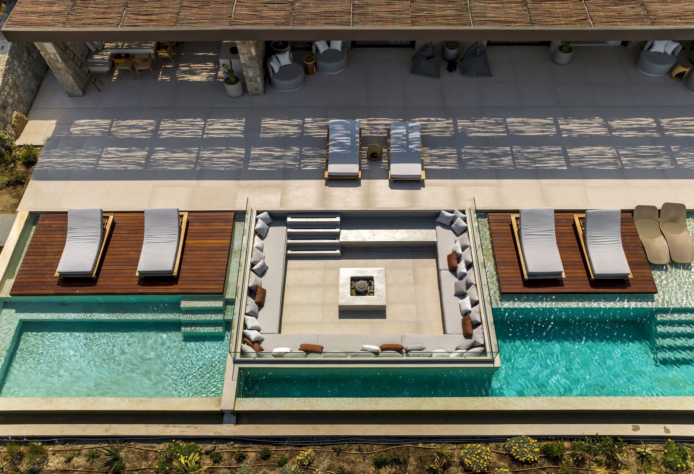 Top-down aerial view of the pool deck and sun loungers at Aether Private Retreat - Ground Floor, Aleomandra, Mykonos