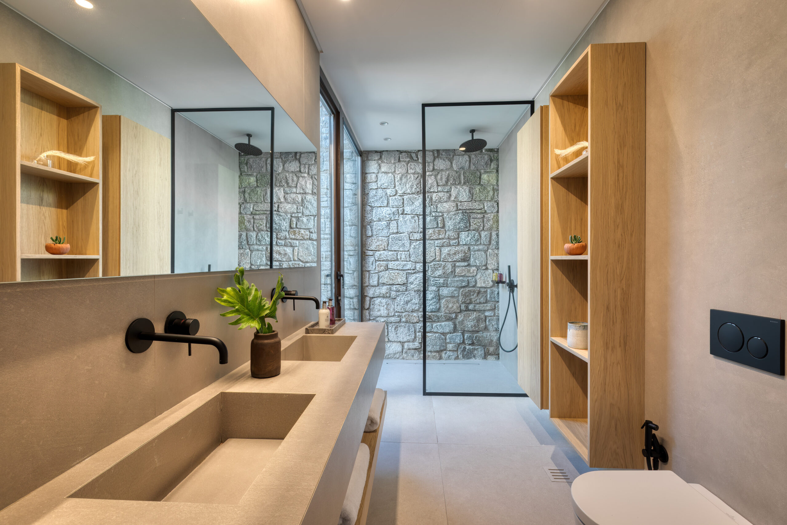 En-suite bathroom with round mirror and stone-finish vanity at Aether Private Retreat - Ground Floor, Aleomandra, Mykonos