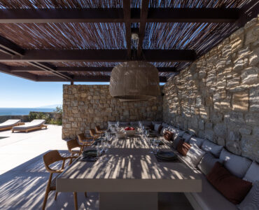 Covered outdoor dining area under a timber pergola at Aether Private Retreat - Ground Floor, Aleomandra, Mykonos