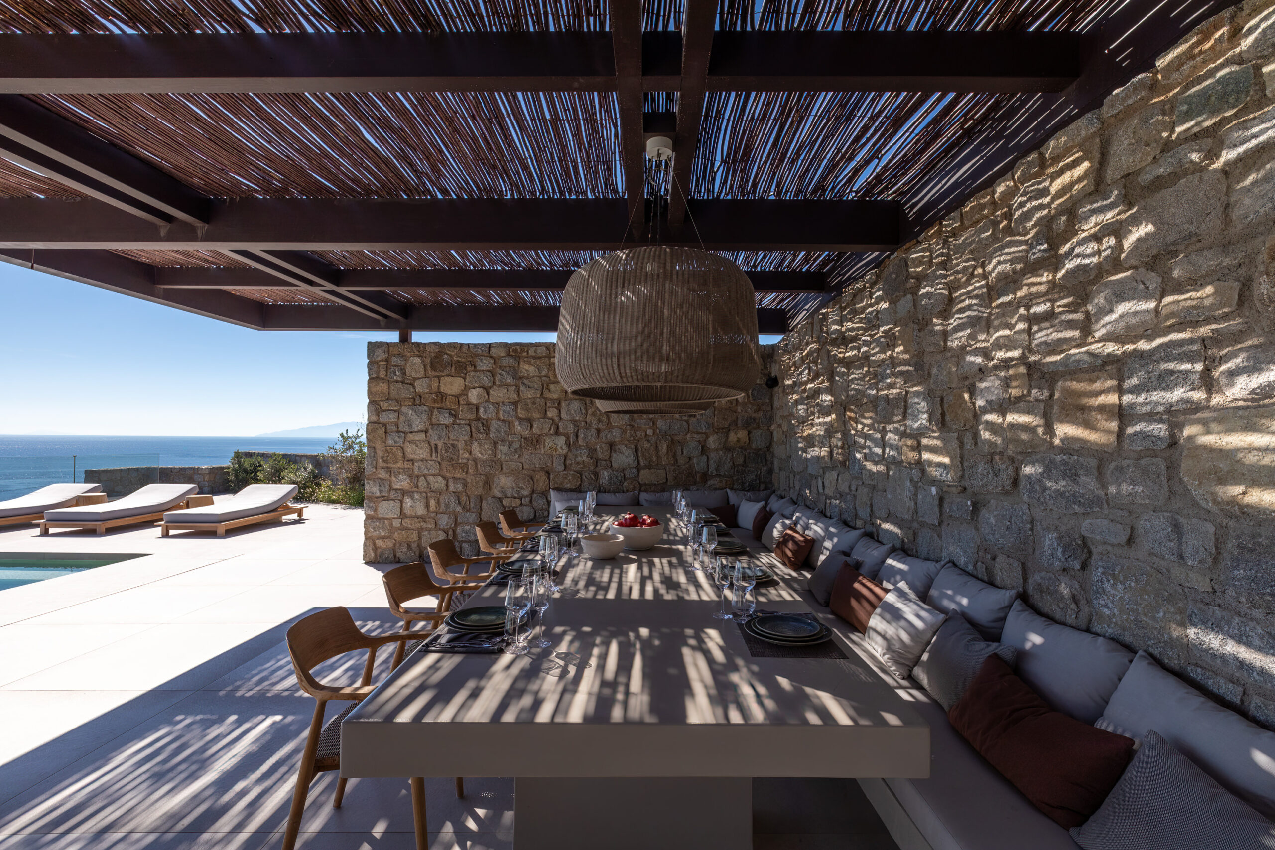 Covered outdoor dining area under a timber pergola at Aether Private Retreat - Ground Floor, Aleomandra, Mykonos