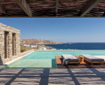 Pool terrace with shaded lounge area and sea views at Aether Private Retreat - Ground Floor, Aleomandra, Mykonos