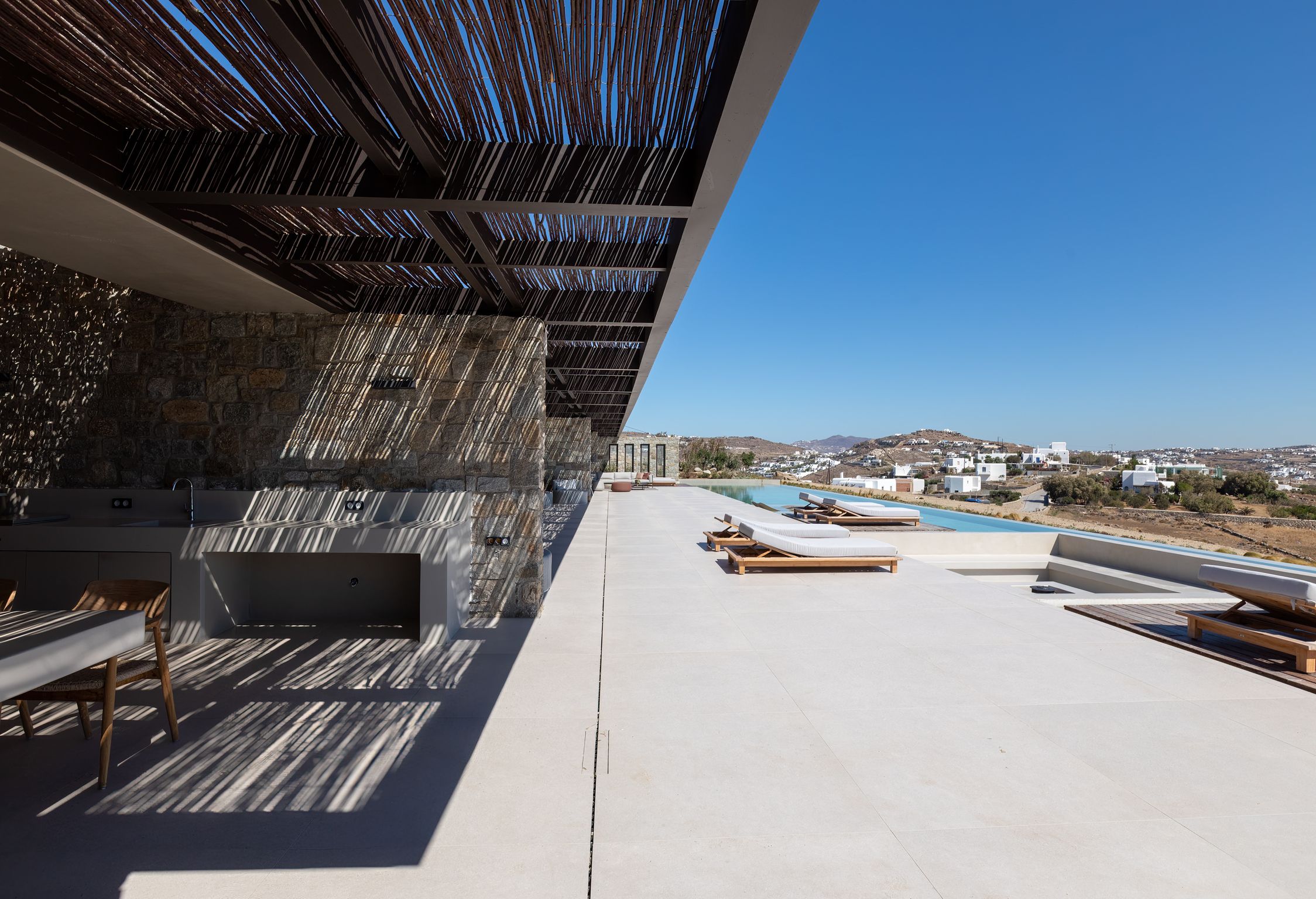 Stone terrace with timber pergola and sea views at Aether Private Retreat - Ground Floor, Aleomandra, Mykonos