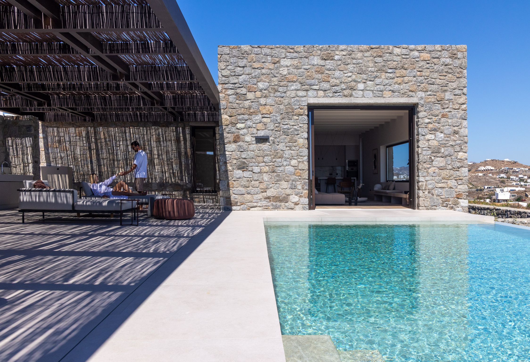 Private pool in front of the villa's stone façade at Aether Private Retreat - Upper Floor, Aleomandra, Mykonos