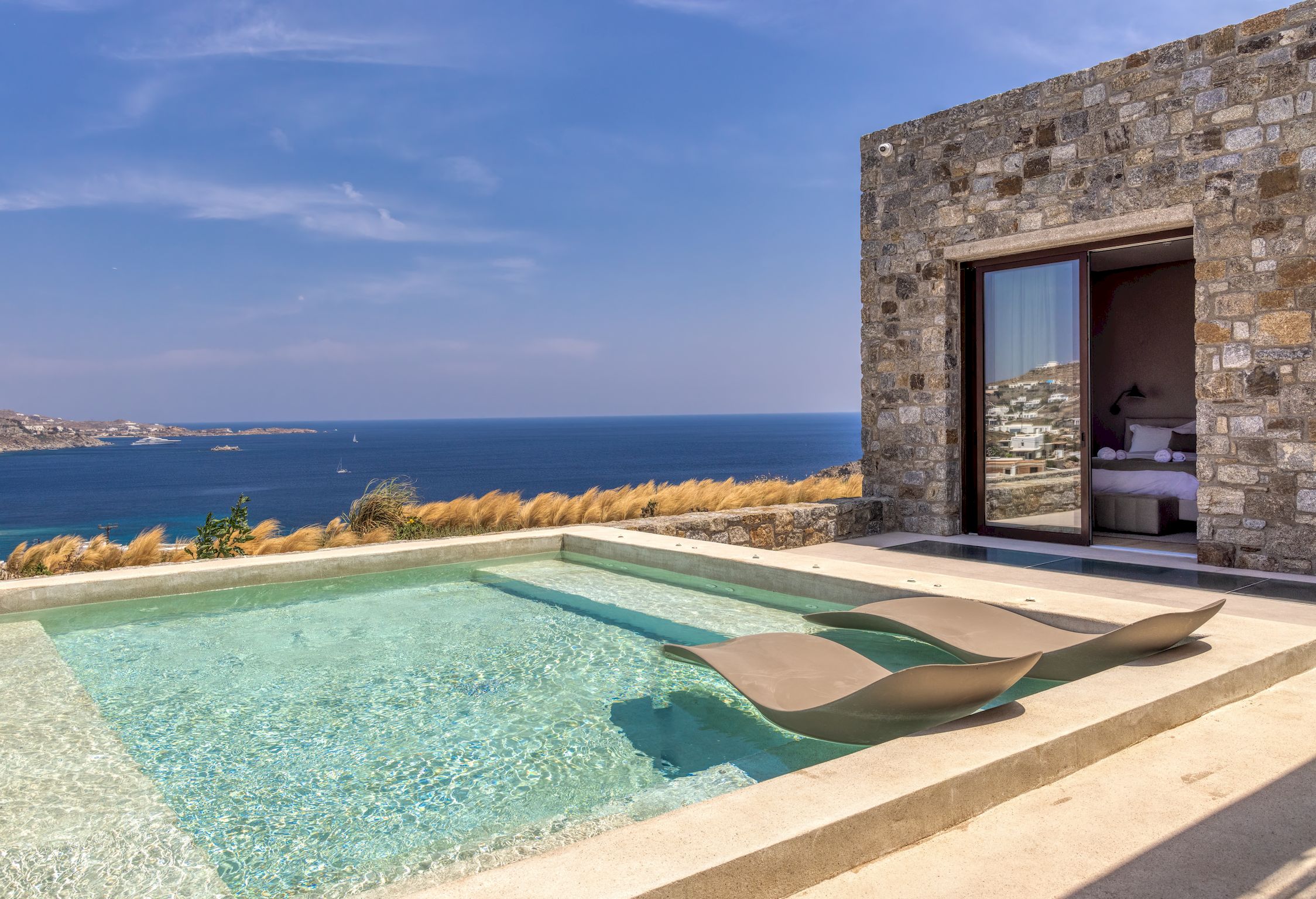Infinity pool with sun deck and loungers overlooking the Aegean Sea at Aether Private Retreat - Upper Floor, Aleomandra, Mykonos