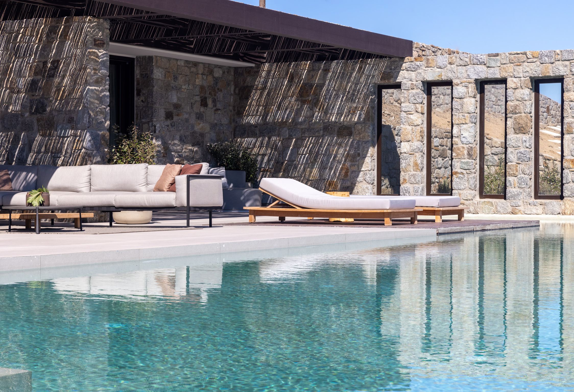 Pool terrace with shaded lounge area and sea views at Aether Private Retreat - Upper Floor, Aleomandra, Mykonos