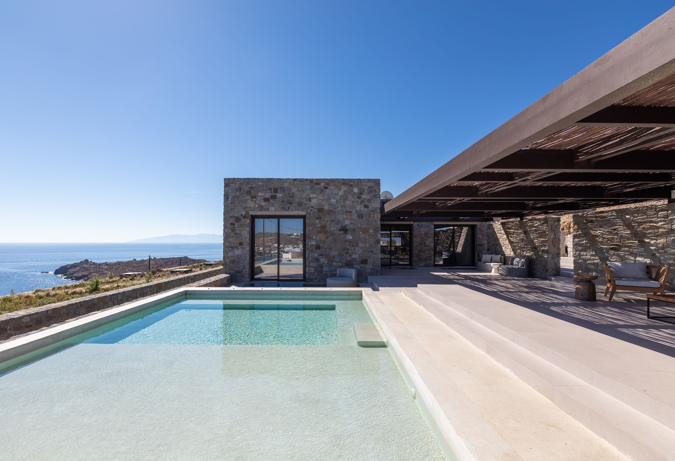 Pool terrace with shaded lounge area and sea views at Aether Private Retreat - Upper Floor, Aleomandra, Mykonos