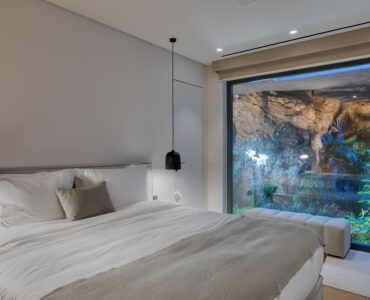 Bedroom with picture window onto the planted garden at Aether Private Retreat - Upper Floor, Aleomandra, Mykonos