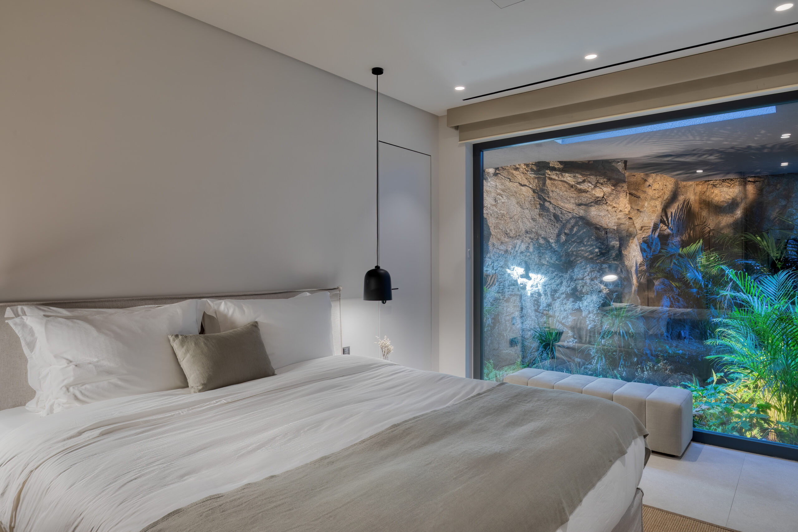 Bedroom with picture window onto the planted garden at Aether Private Retreat - Upper Floor, Aleomandra, Mykonos
