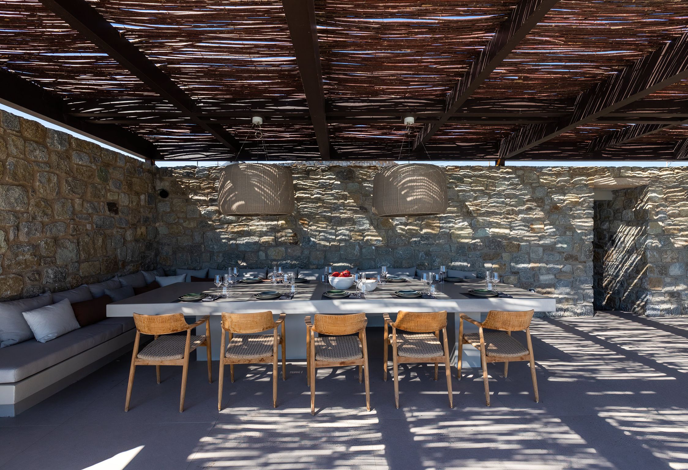 Covered outdoor dining area under a timber pergola at Aether Private Retreat - Upper Floor, Aleomandra, Mykonos