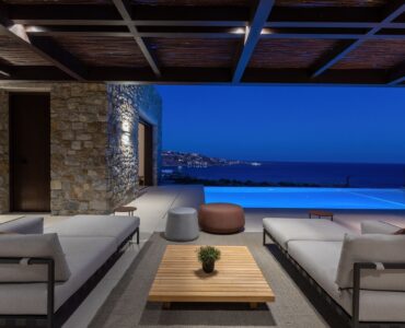 Covered outdoor lounge lit at night at Aether Private Retreat - Upper Floor, Aleomandra, Mykonos