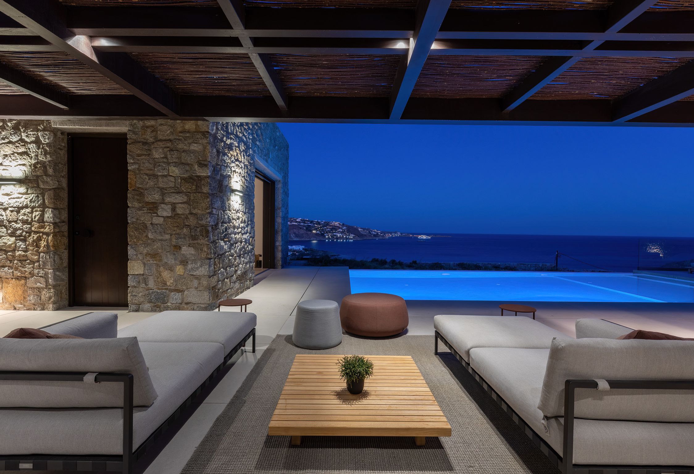 Covered outdoor lounge lit at night at Aether Private Retreat - Upper Floor, Aleomandra, Mykonos