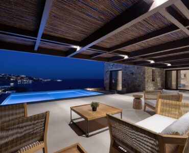 Covered outdoor lounge lit at night at Aether Private Retreat - Upper Floor, Aleomandra, Mykonos