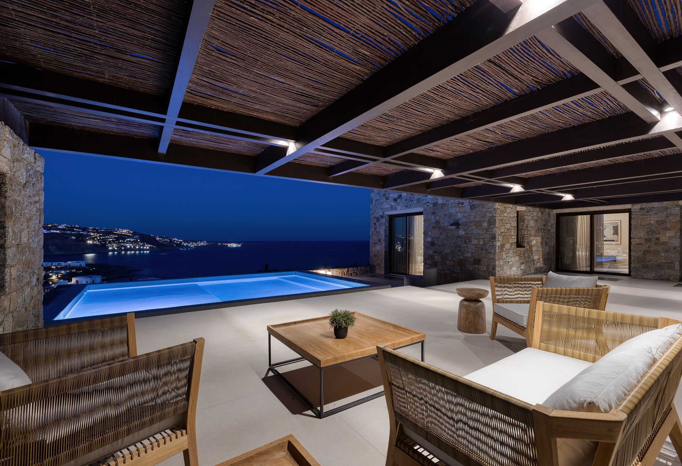 Covered outdoor lounge lit at night at Aether Private Retreat - Upper Floor, Aleomandra, Mykonos
