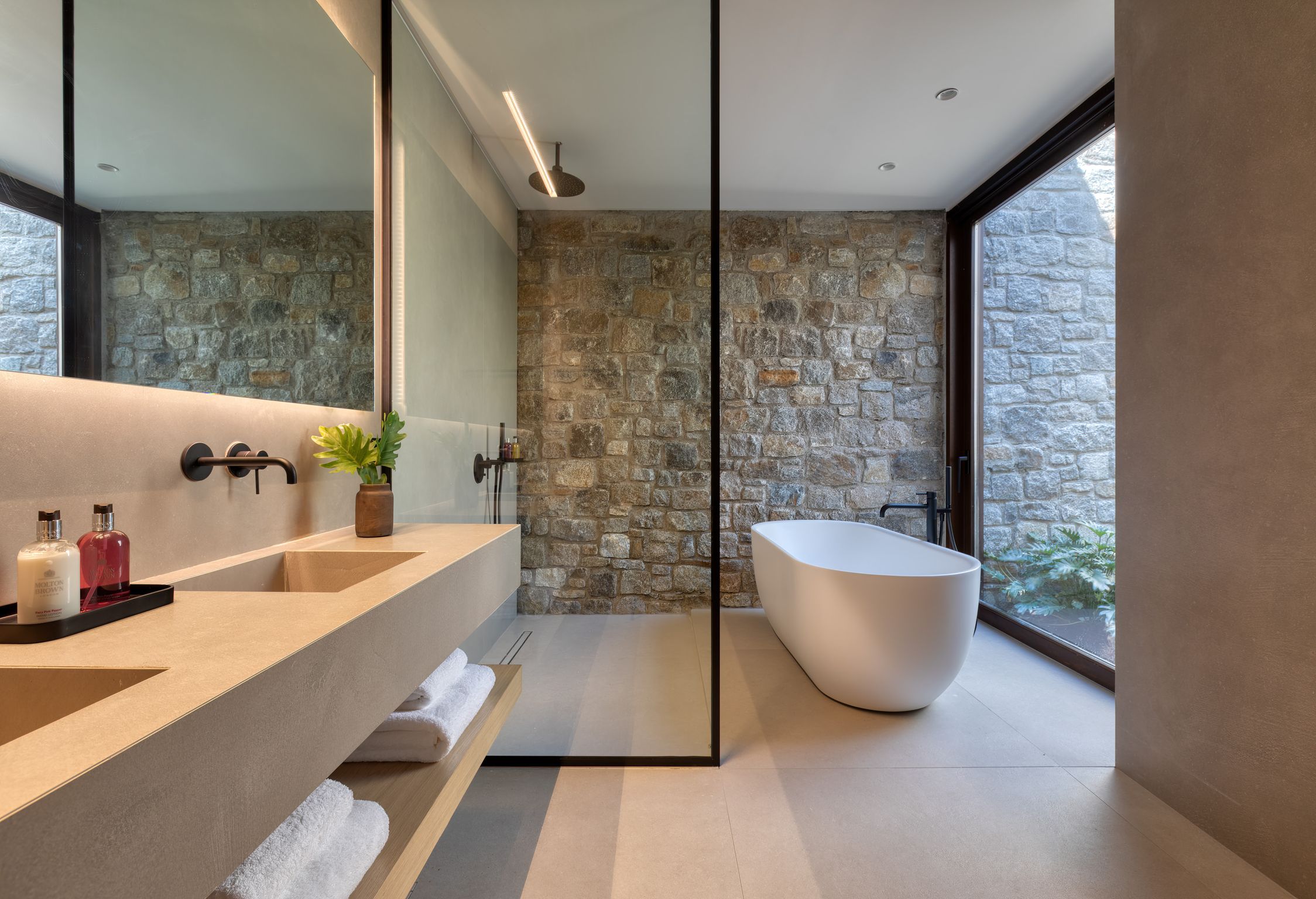 En-suite bathroom with freestanding bathtub and stone walls at Aether Private Retreat - Upper Floor, Aleomandra, Mykonos
