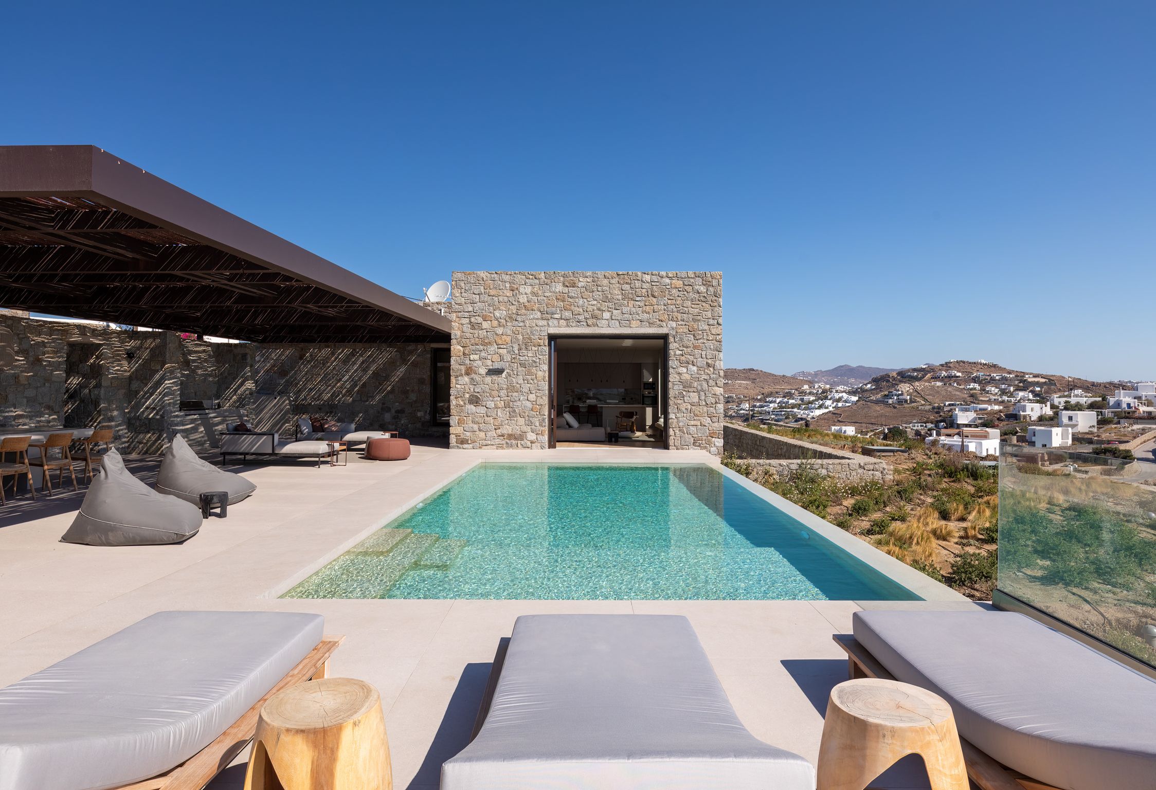 Private pool with sun loungers beside the stone-built villa at Aether Private Retreat - Upper Floor, Aleomandra, Mykonos