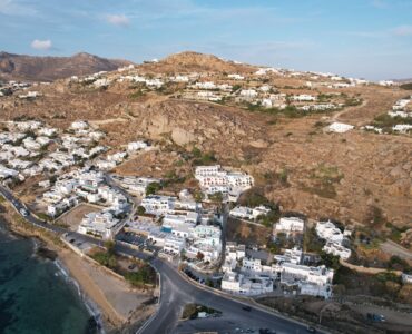 Aerial drone view of seafront house at Agia Anna Gyalos beach Mykonos Town for sale