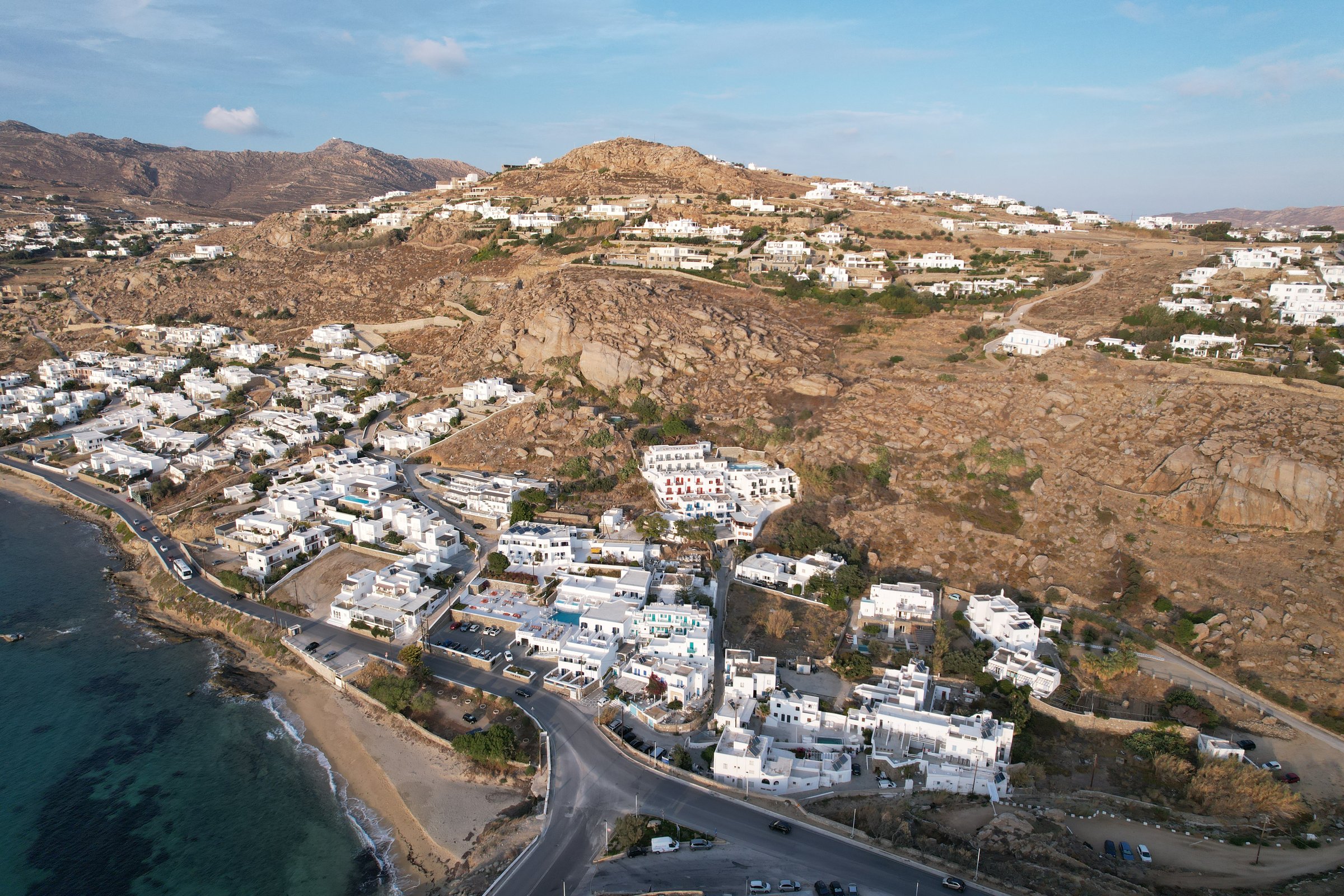 Aerial drone view of seafront house at Agia Anna Gyalos beach Mykonos Town for sale