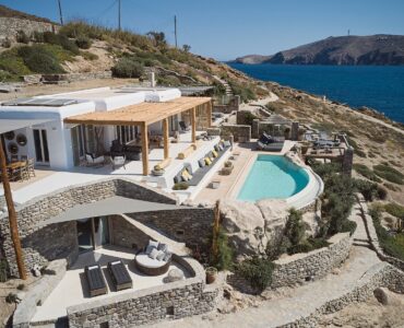 Aerial view of the sea front villa and infinity pool above Ftelia beach at Bali Sea Front Villa in Ftelia, Mykonos