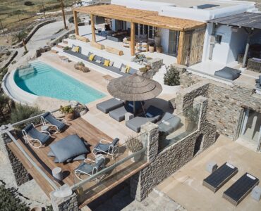 Aerial view of the sea front villa and infinity pool above Ftelia beach at Bali Sea Front Villa in Ftelia, Mykonos