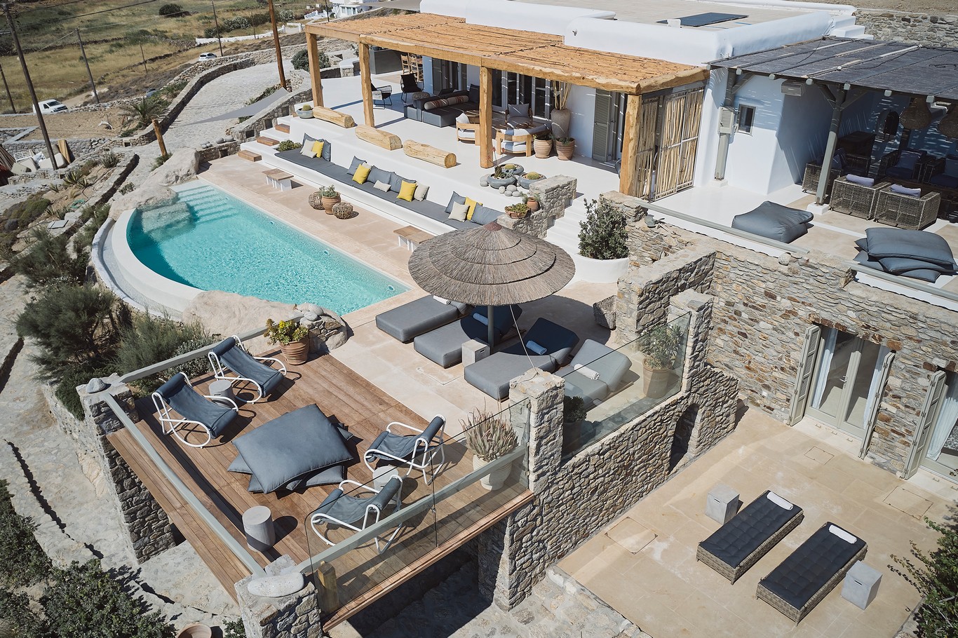 Aerial view of the sea front villa and infinity pool above Ftelia beach at Bali Sea Front Villa in Ftelia, Mykonos