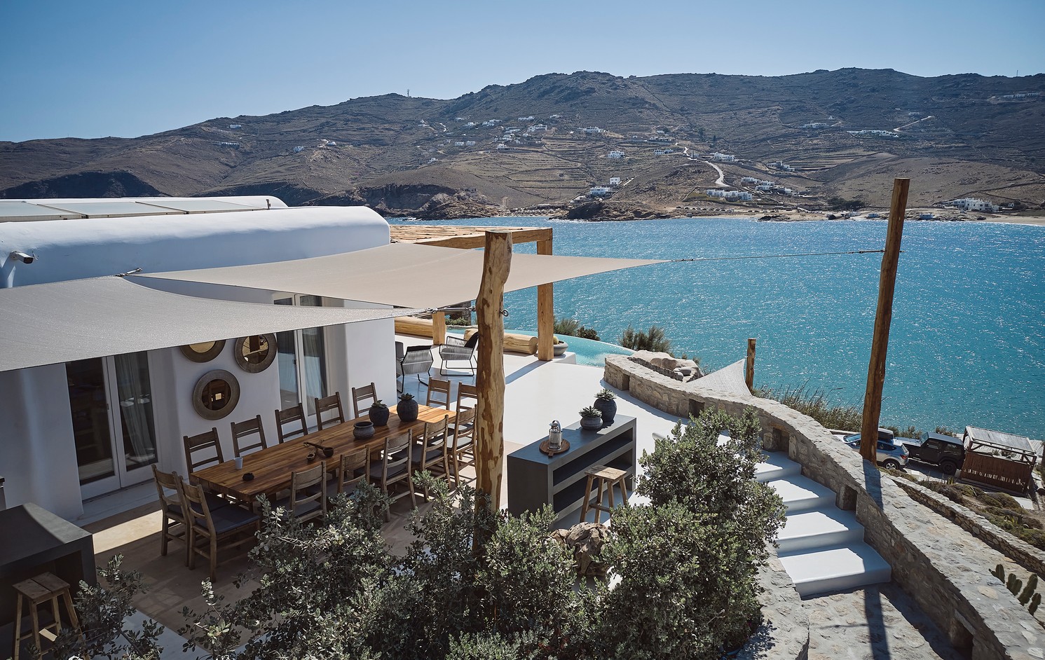 Shaded BBQ and alfresco dining area with sea views at Bali Sea Front Villa in Ftelia, Mykonos