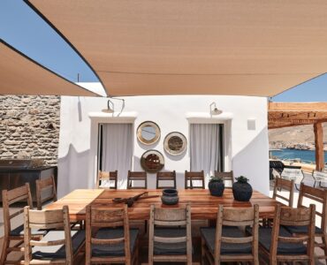 Shaded BBQ and alfresco dining area with sea views (view 2) at Bali Sea Front Villa in Ftelia, Mykonos