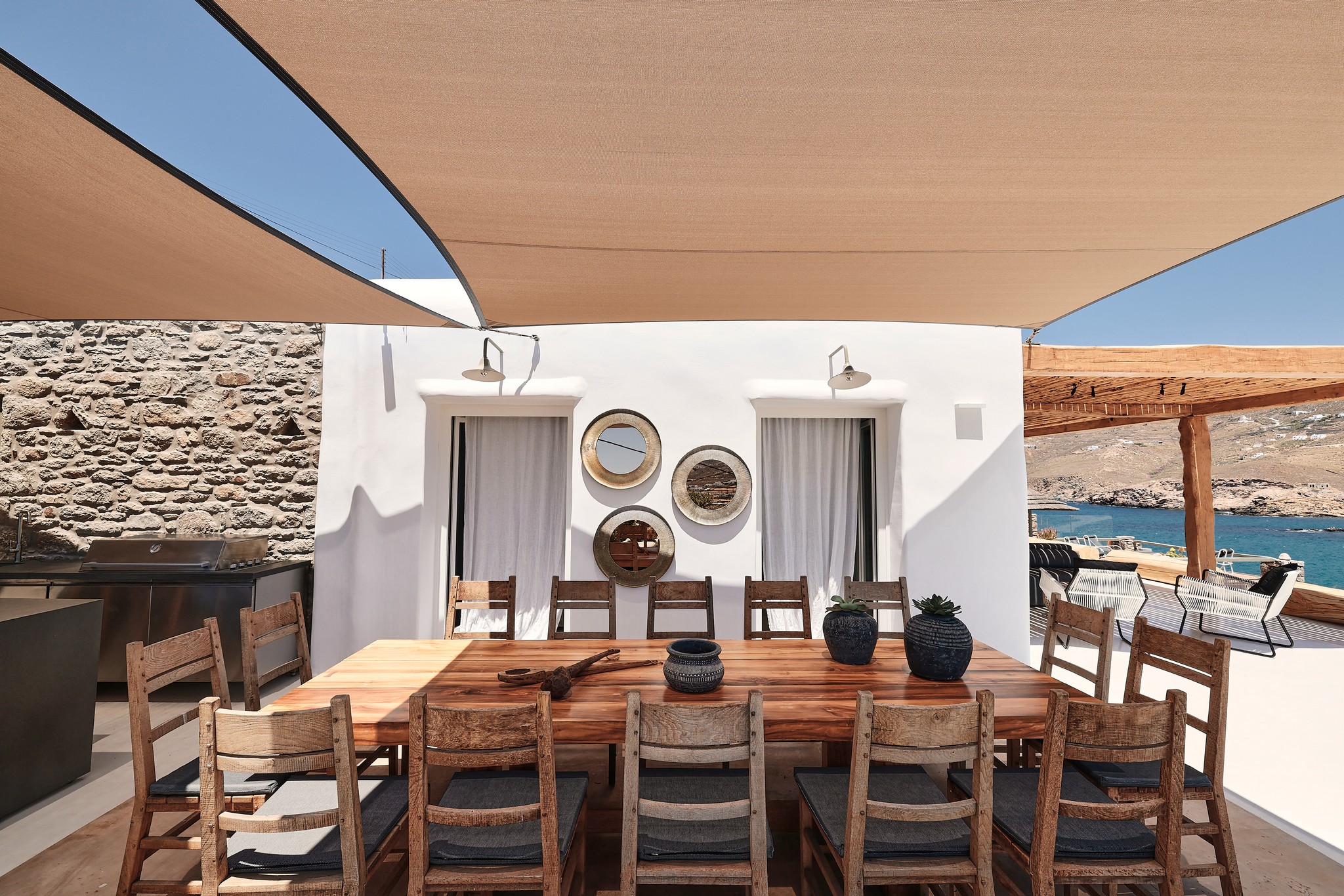 Shaded BBQ and alfresco dining area with sea views (view 2) at Bali Sea Front Villa in Ftelia, Mykonos