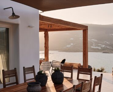 Shaded BBQ and alfresco dining area with sea views (view 5) at Bali Sea Front Villa in Ftelia, Mykonos
