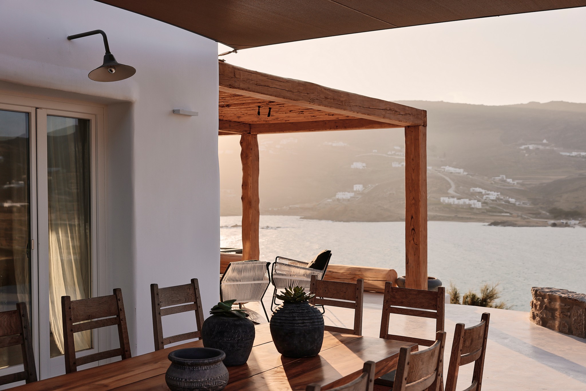 Shaded BBQ and alfresco dining area with sea views (view 5) at Bali Sea Front Villa in Ftelia, Mykonos