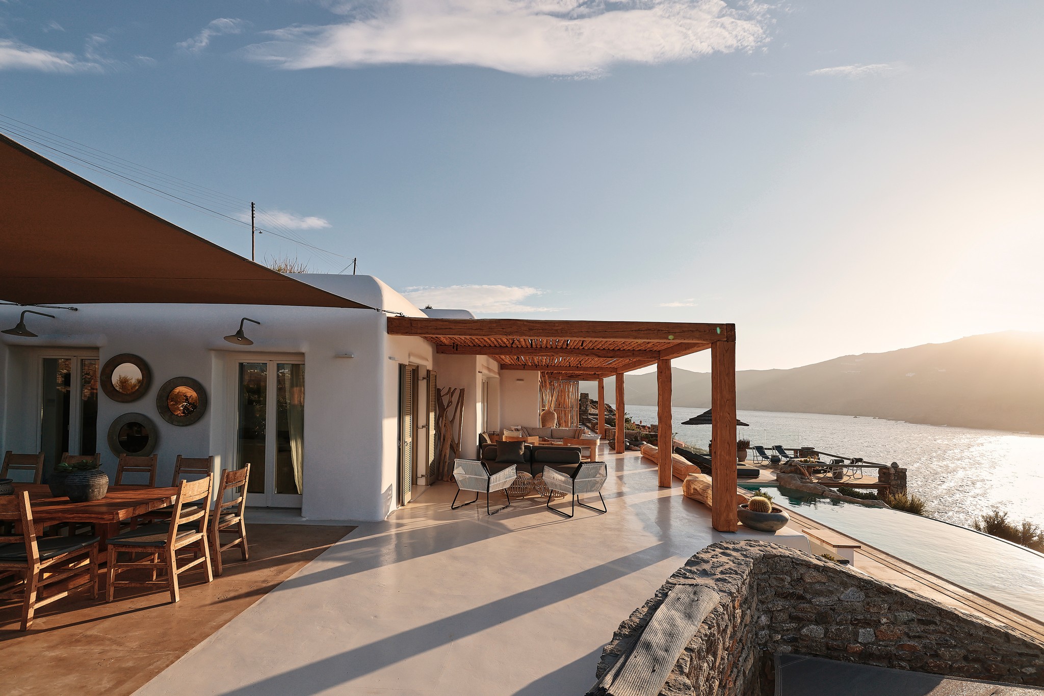 Shaded veranda lounge facing the Aegean Sea at Bali Sea Front Villa in Ftelia, Mykonos