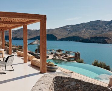 Infinity pool with sun loungers and views over Ftelia bay (view 6) at Bali Sea Front Villa in Ftelia, Mykonos