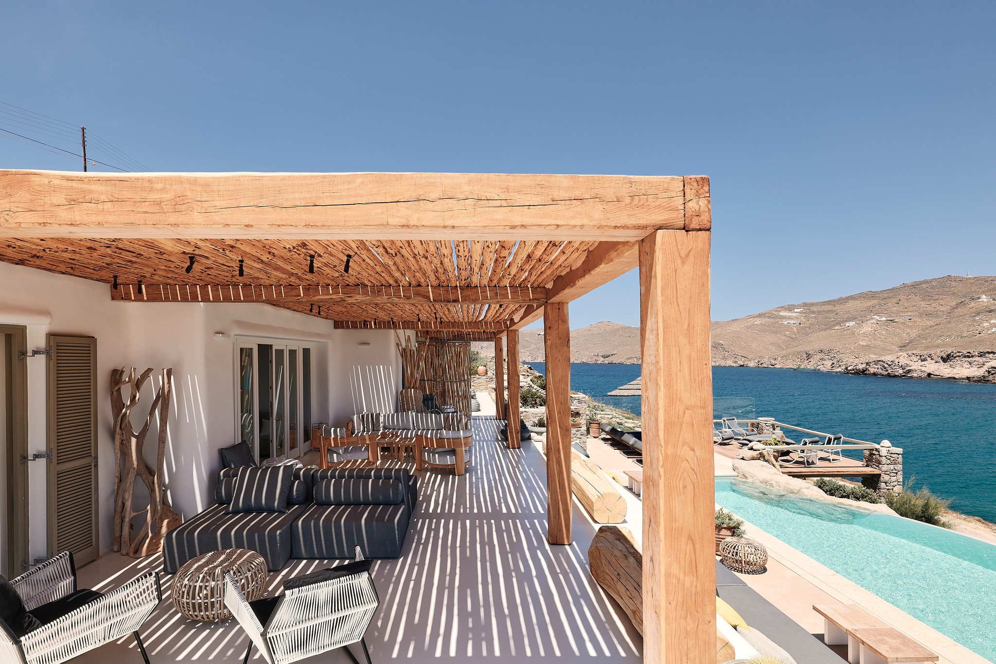 Shaded veranda lounge facing the Aegean Sea (view 3) at Bali Sea Front Villa in Ftelia, Mykonos