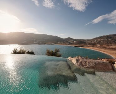 Infinity pool with sun loungers and views over Ftelia bay (view 7) at Bali Sea Front Villa in Ftelia, Mykonos