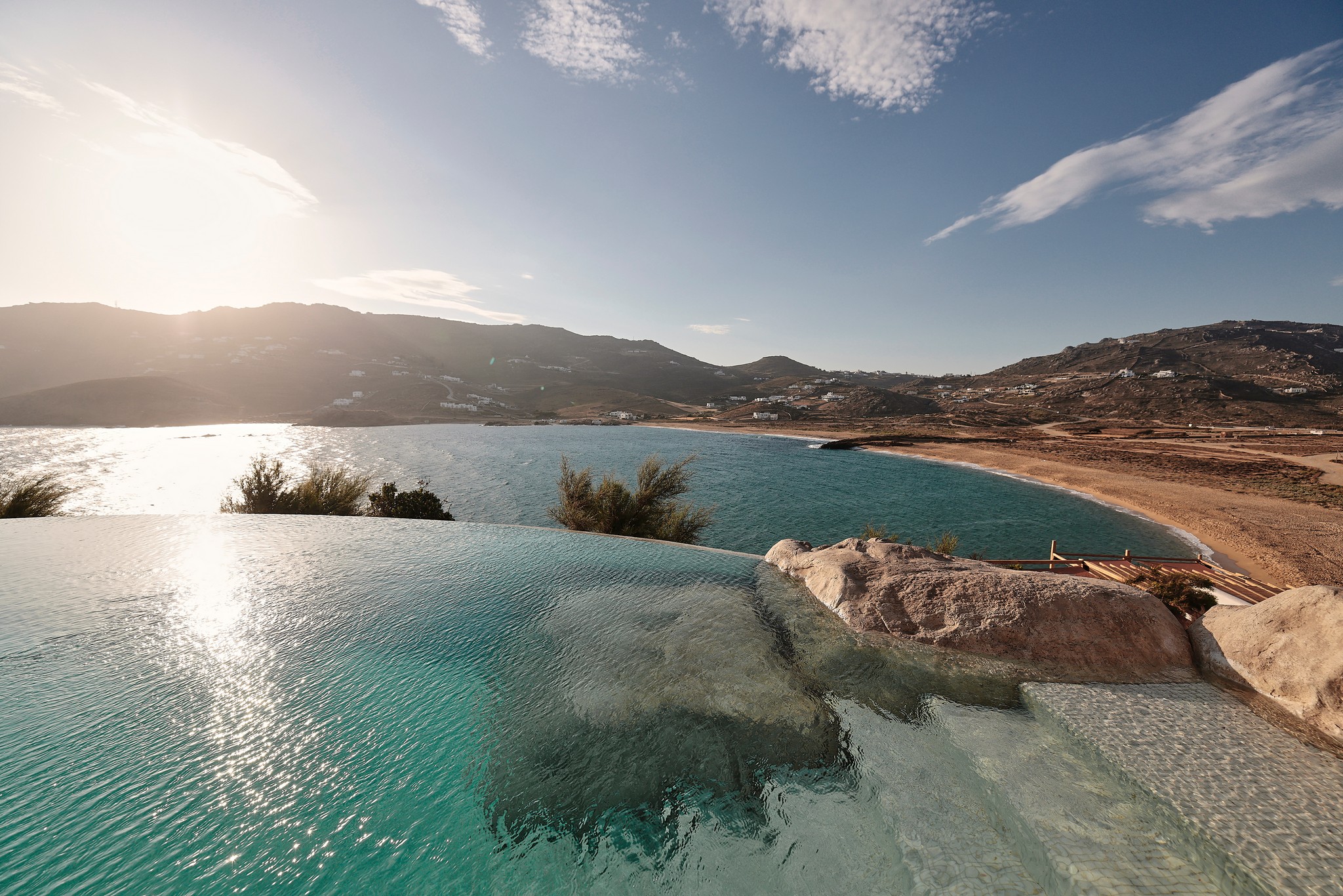 Infinity pool with sun loungers and views over Ftelia bay (view 7) at Bali Sea Front Villa in Ftelia, Mykonos