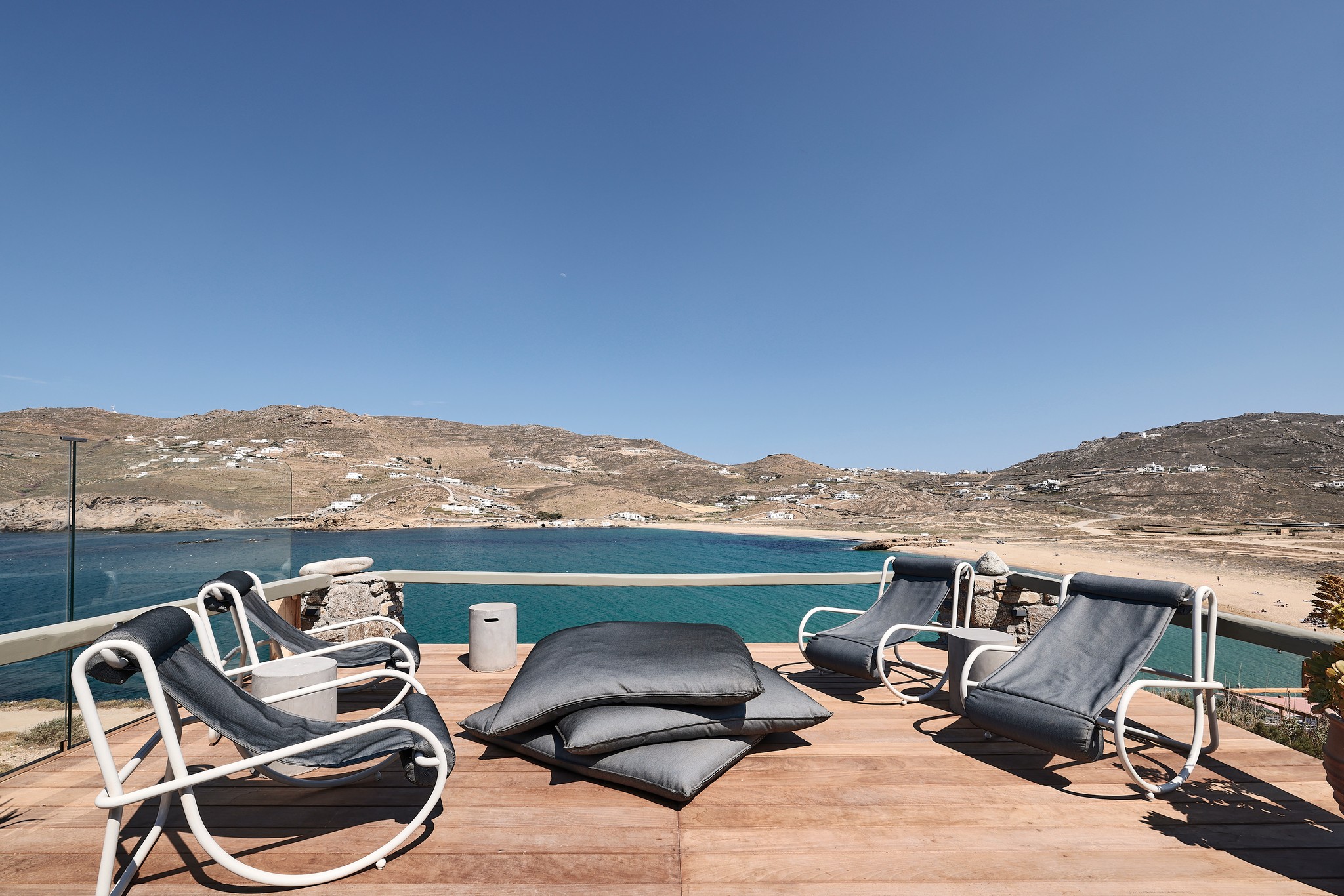 Infinity pool with sun loungers and views over Ftelia bay (view 8) at Bali Sea Front Villa in Ftelia, Mykonos