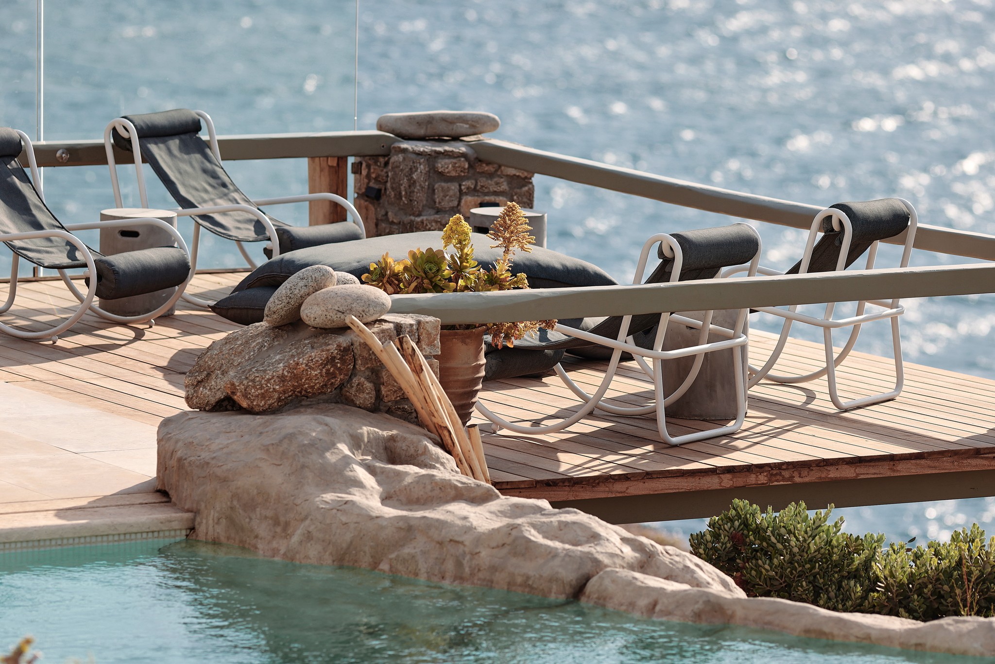 Infinity pool with sun loungers and views over Ftelia bay (view 9) at Bali Sea Front Villa in Ftelia, Mykonos
