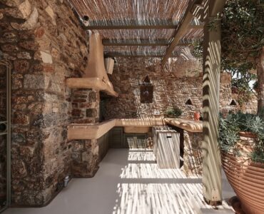 Patio with built-in BBQ and outdoor seating at Bali Sea Front Villa in Ftelia, Mykonos