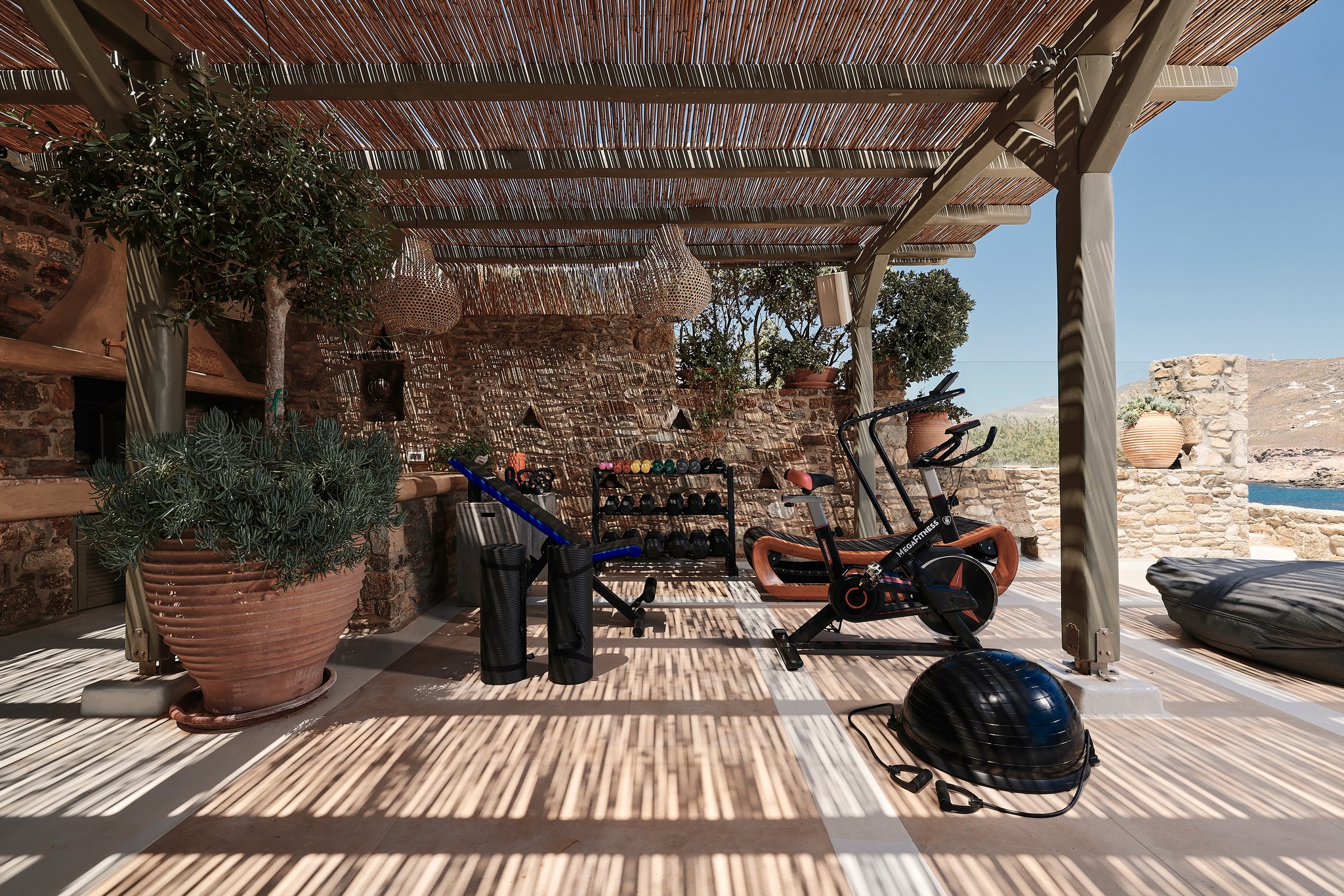 Outdoor gym area with sea views at Bali Sea Front Villa in Ftelia, Mykonos