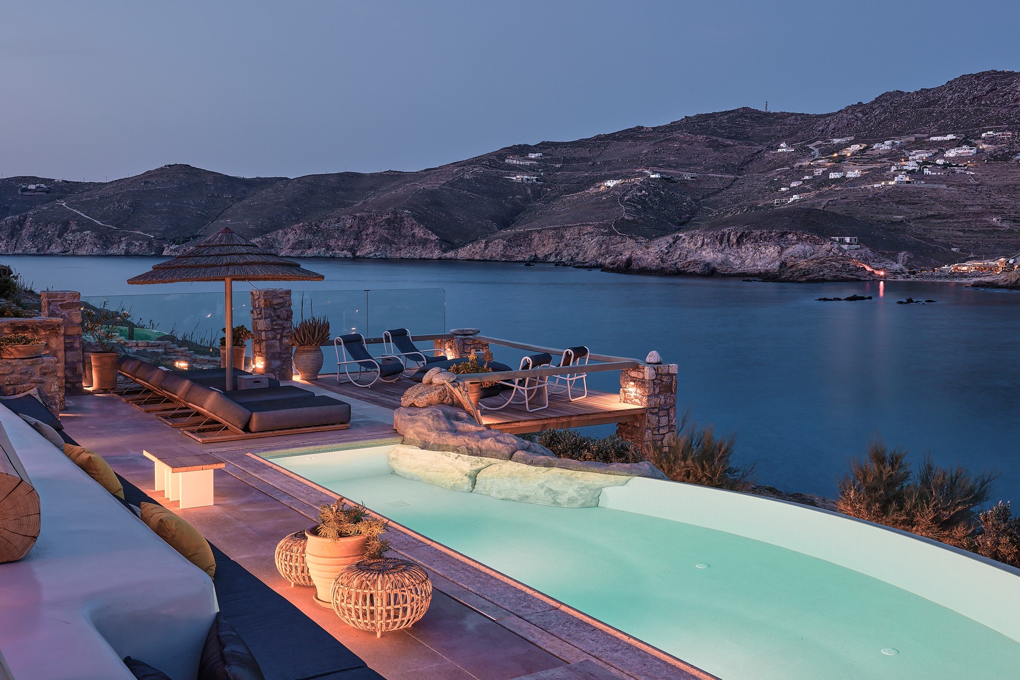 Infinity pool with sun loungers and views over Ftelia bay (view 10) at Bali Sea Front Villa in Ftelia, Mykonos