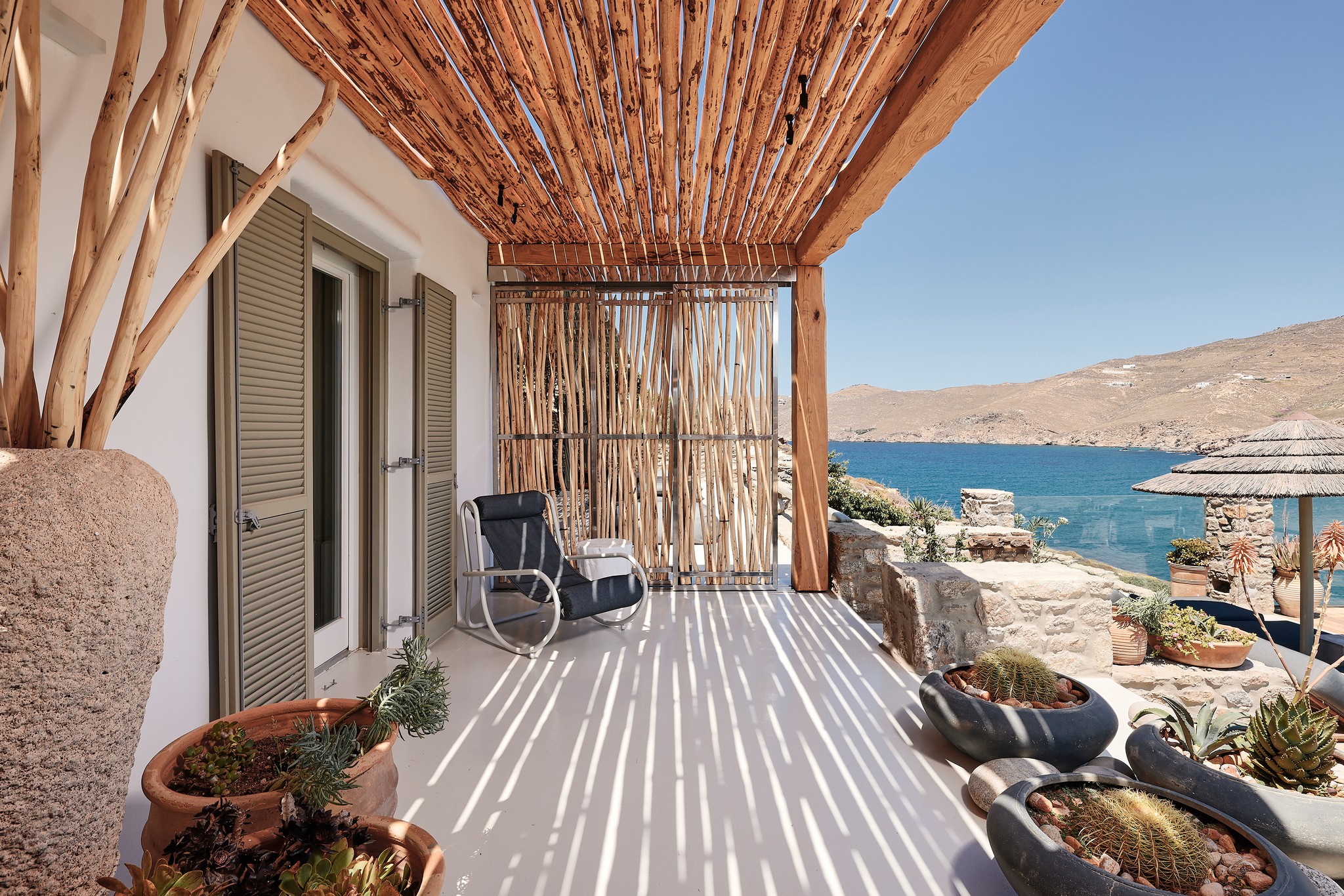 Master bedroom on the upper level of the main house (view 2) at Bali Sea Front Villa in Ftelia, Mykonos