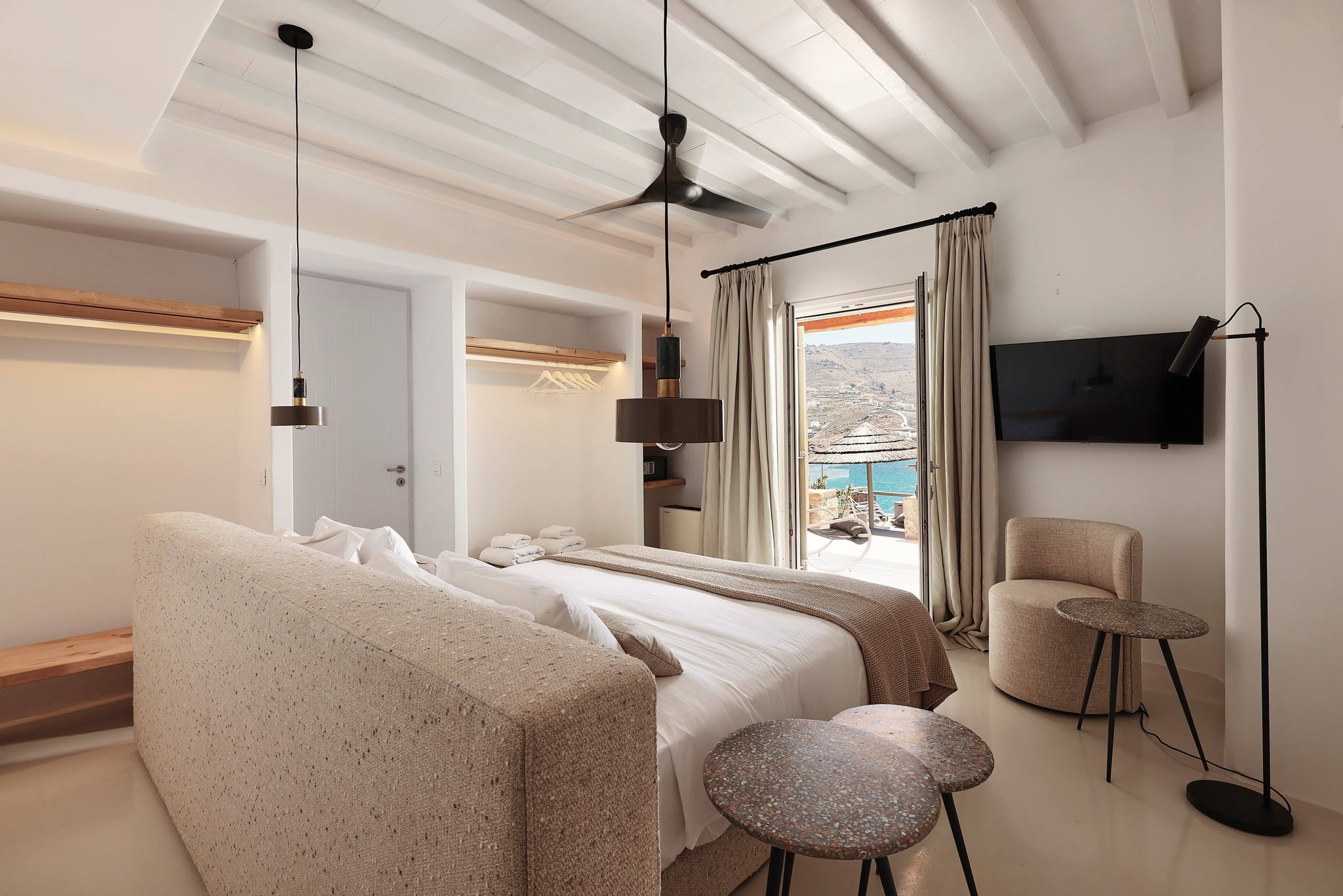 Master bedroom on the upper level of the main house (view 4) at Bali Sea Front Villa in Ftelia, Mykonos