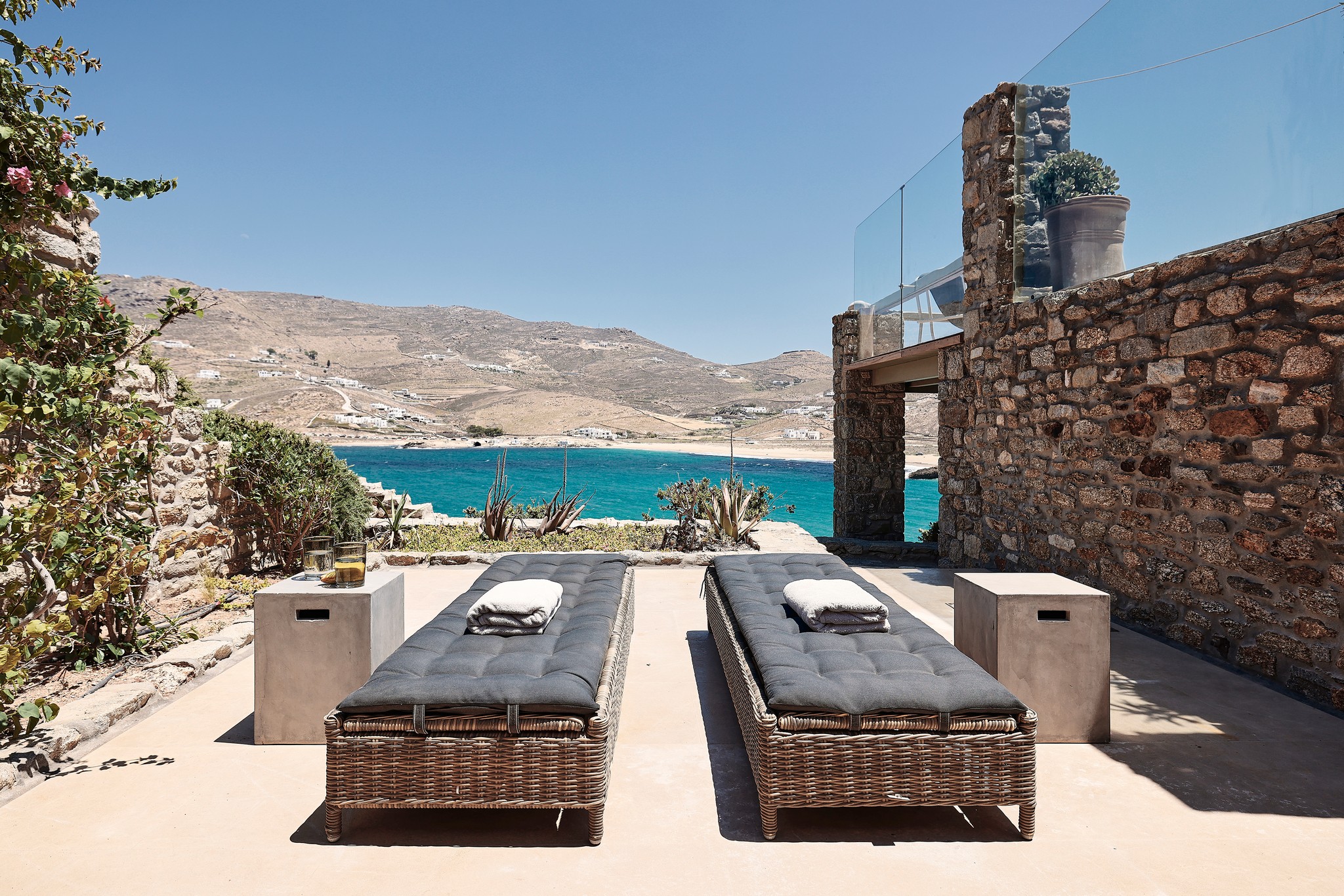 Shared veranda of the lower-level bedrooms at Bali Sea Front Villa in Ftelia, Mykonos